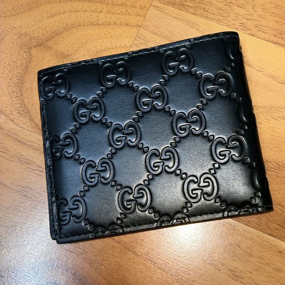 Authentic Gucci Dorian Signature Embossed Leather Bifold Wallet